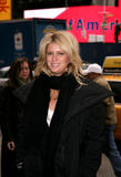 Rachel Hunter walks into a Times Square information center in New York City