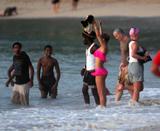 Rihanna in small pink bikini showing off her body on the beach in Barbados -